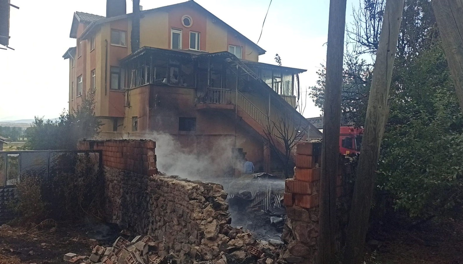Konya'da bir kişinin konutunun önündeki otları yakması için yaktığı ateş,