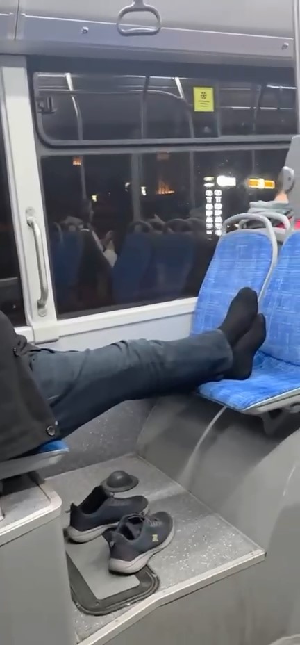 Bursa'da otobüsle seyreden bir şahıs, ayakkabılarını çıkararak ayaklarını karşısında olan